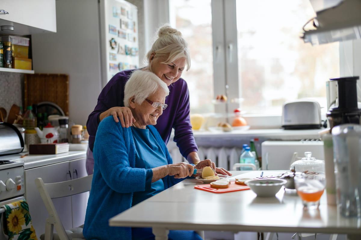 Senior woman and daughter prepare meal