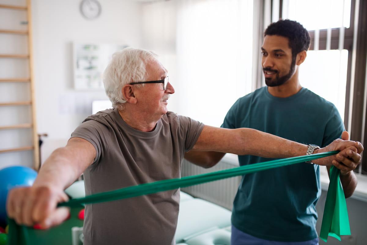 Senior man with physiotherapist